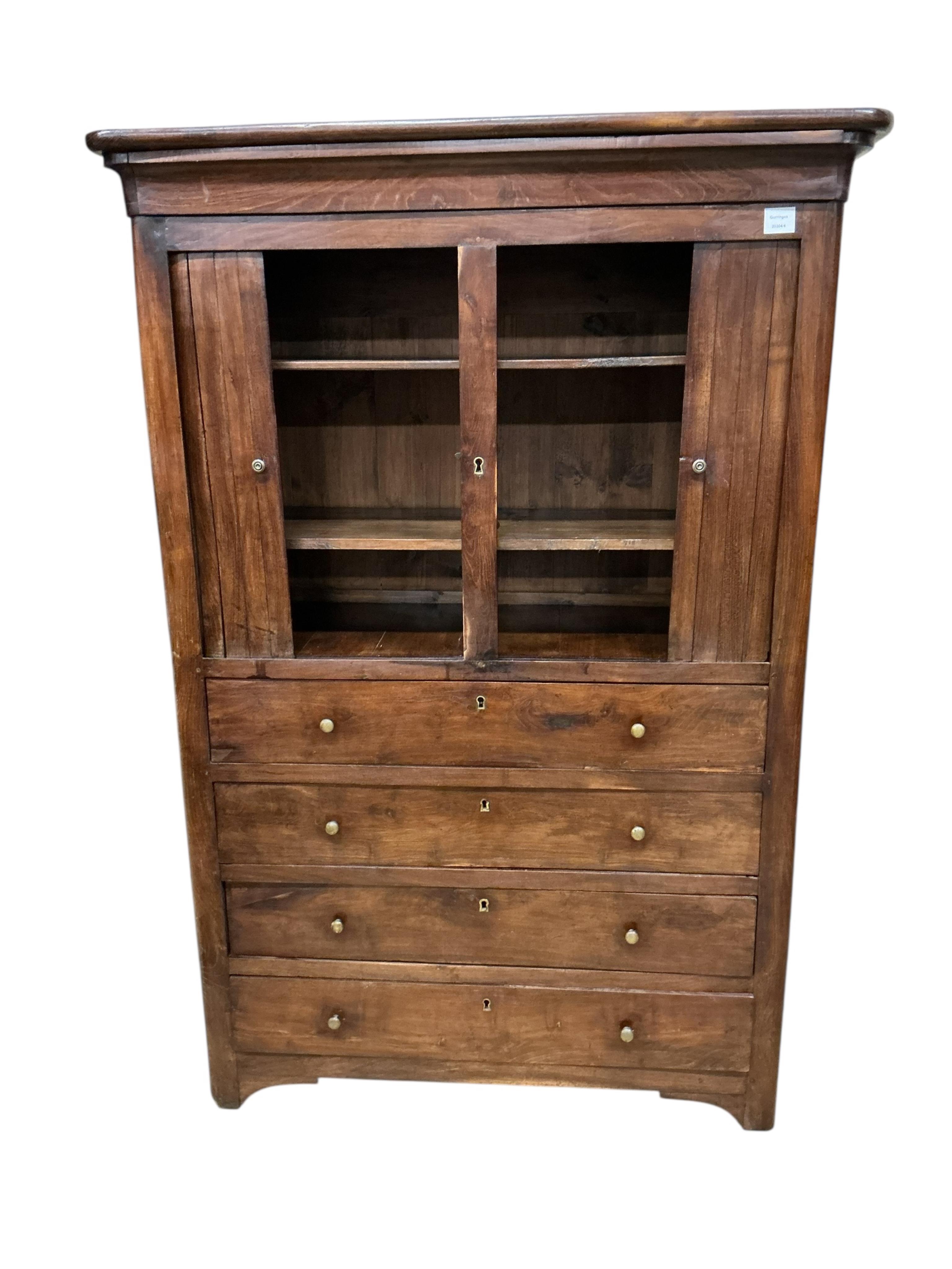 A cabinet, the upper section with twin tambour doors, enclosing a shelved interior, above the lower section with four long drawers, width 108cm, depth 45cm, height 158cm